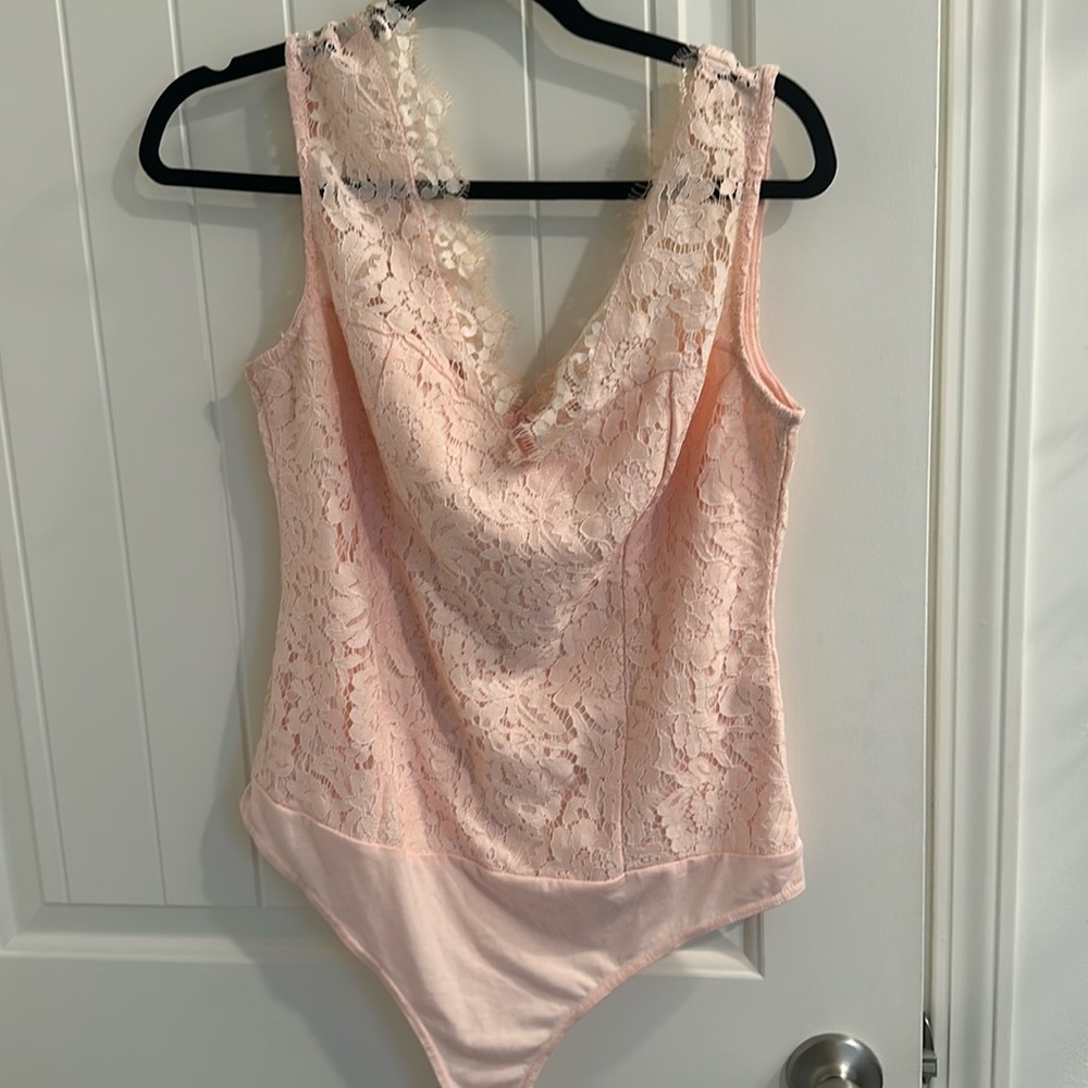 Lace v neck body suit in cream ish pink color I believe Eva mendes for NYCo